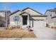Charming two-story home with a welcoming front porch and attached two-car garage at 7285 S Titus Way, Aurora, CO 80016