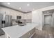 Modern kitchen featuring white cabinets, stainless steel appliances, and a large island at 7285 S Titus Way, Aurora, CO 80016