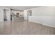 Open-concept kitchen and dining area with modern appliances and wood-look flooring at 7285 S Titus Way, Aurora, CO 80016