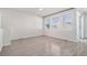 Spacious living room with large windows, wood-look flooring, and ample natural light at 7285 S Titus Way, Aurora, CO 80016