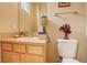 Small bathroom with a toilet, sink, and mirror at 2855 Rock Creek Cir # 129, Superior, CO 80027