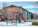 Community playground with playset and bench in snowy setting at 2855 Rock Creek Cir # 129, Superior, CO 80027