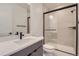 Modern bathroom with a shower, toilet and vanity with quartz top at 11575 Toccata Trl, Parker, CO 80134