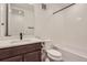 Clean bathroom, featuring a bathtub, toilet and vanity with dark brown cabinets at 11575 Toccata Trl, Parker, CO 80134
