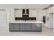 Modern kitchen with gray island and white cabinets at 11575 Toccata Trl, Parker, CO 80134