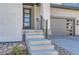 Modern home exterior with a gray door and attached garage at 11575 Toccata Trl, Parker, CO 80134