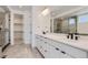 Double vanity bathroom with quartz countertop and black fixtures at 11575 Toccata Trl, Parker, CO 80134