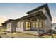 Two-story house with gray siding, covered patio, and landscaped yard at 11575 Toccata Trl, Parker, CO 80134