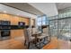 Modern kitchen with light wood cabinets, black tile backsplash, and city view at 1700 Bassett St # 903, Denver, CO 80202