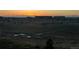 View of green space and bridge at sunset with a school in the background at 27413 E 1St Pl, Aurora, CO 80018