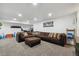 Finished basement with a large sectional sofa, offering ample space for relaxation at 5926 W Long Dr, Littleton, CO 80123