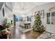 Bright dining room with hardwood floors, a large table, and a Christmas tree at 5926 W Long Dr, Littleton, CO 80123