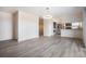 Open dining area with wood accent wall and vinyl flooring at 1830 Simms St, Lakewood, CO 80215