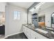 Elegant bathroom with double sinks, granite countertops, and a view of the bedroom at 22020 E Belleview Pl, Aurora, CO 80015