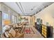 Spacious living room with large windows, hardwood floors, and comfortable furniture at 1610 Little Raven St # 407, Denver, CO 80202