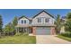 Two-story house with gray siding, brick accents, and a two-car garage at 3953 S Killarney Way, Aurora, CO 80013