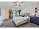 Main bedroom features gray upholstered bed and barn door at 3953 S Killarney Way, Aurora, CO 80013