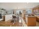 Eat-in kitchen with wood cabinets, island, and sliding glass doors at 7459 S Lewiston St, Aurora, CO 80016