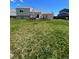 House back exterior showing a large grassy yard and wooden deck at 1415 S Pitkin Ct, Aurora, CO 80017