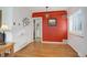 Dining room with hardwood floors and an accent wall at 2488 S Zurich Ct, Denver, CO 80219