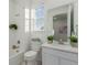 Bright bathroom with a bathtub, toilet and vanity at 15881 Willow Way, Thornton, CO 80602