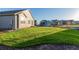 Large grassy backyard with mature trees and landscaping at 15881 Willow Way, Thornton, CO 80602