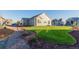 Landscaped backyard with grassy area, gravel pathway and mature trees at 15881 Willow Way, Thornton, CO 80602