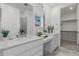 Elegant bathroom with a double vanity and walk-in closet at 15881 Willow Way, Thornton, CO 80602