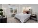 Cozy bedroom with a queen-size bed and large window at 15881 Willow Way, Thornton, CO 80602