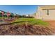 Landscaped backyard with grassy area and mature trees at 15881 Willow Way, Thornton, CO 80602