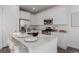 Modern kitchen features stainless steel appliances and white cabinetry at 15881 Willow Way, Thornton, CO 80602