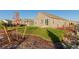 Landscaped backyard with grassy area and mature trees at 15881 Willow Way, Thornton, CO 80602