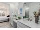 Bathroom with double vanity and view into bedroom at 15881 Willow Way, Thornton, CO 80602