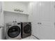 Bright laundry room with washer and dryer and storage at 15881 Willow Way, Thornton, CO 80602