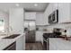 Modern kitchen with stainless steel appliances at 15881 Willow Way, Thornton, CO 80602
