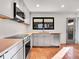 Modern kitchen with gray cabinets, butcher block counters, and terracotta tile floor at 1130 Locust St, Denver, CO 80220