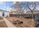 Backyard with a wooden fence, patio, and mature trees at 2229 S Bannock St, Denver, CO 80223