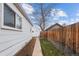 A narrow backyard with a walkway, wooden fence, and small shed at 2229 S Bannock St, Denver, CO 80223