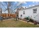 Backyard with detached garage, weight bench, and lawn equipment at 2229 S Bannock St, Denver, CO 80223