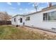 White ranch home with a small front yard and walkway at 2229 S Bannock St, Denver, CO 80223