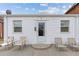 White bungalow home with chairs on a small patio at 2229 S Bannock St, Denver, CO 80223