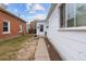 White ranch home with a small front yard and walkway next to a brick home at 2229 S Bannock St, Denver, CO 80223