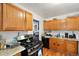Bright kitchen with wood cabinets, gas range, and stainless steel appliances at 2229 S Bannock St, Denver, CO 80223