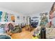 Living room features hardwood floors, a Christmas tree, and a flatscreen TV at 2229 S Bannock St, Denver, CO 80223