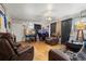 Living room with brown leather furniture and hardwood floors at 2229 S Bannock St, Denver, CO 80223