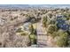 Aerial view of a neighborhood street lined with trees and townhomes with mountain views at 1155 S Harlan St, Lakewood, CO 80232