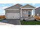 Craftsman style home with two-car garage and landscaped front yard at 7318 Arkansas St, Frederick, CO 80530
