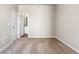 Spacious bedroom with neutral walls and carpet flooring, adjacent to bathroom at 7318 Arkansas St, Frederick, CO 80530