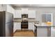 Well-equipped kitchen featuring granite countertops and white cabinets at 7318 Arkansas St, Frederick, CO 80530