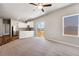 Living room with kitchen, sliding door, and ceiling fan at 7318 Arkansas St, Frederick, CO 80530